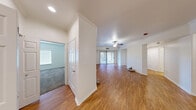 Located at 9550 W Sahara Ave in Las Vegas, NV, this single-floor, 3-bedroom, 2-bathroom home offers a well-designed layout with a comfortable and functional living environment. The open living room features warm wood-look flooring, crown molding, and a ceiling fan, with a sliding glass door that leads to a covered patio and a private outdoor area landscaped with turf, decorative gravel, and mature trees — creating a serene retreat. The kitchen is outfitted with crisp white shaker cabinetry, a subway tile backsplash, quartz countertops, stainless steel appliances including a refrigerator, microwave, and gas range, and a breakfast bar peninsula ideal for casual dining. The three bedrooms are carpeted and well-lit with natural light from windows fitted with blinds. The primary bedroom includes a closet and ample space, while additional bedrooms offer similar comfort. Two bathrooms provide practicality, one featuring a full tub-shower combination with clean white tile. A hallway connects the living spaces efficiently, and two closets offer added storage. The overall ambiance is bright, clean, and move-in ready, making this Las Vegas home a practical and inviting place to live.