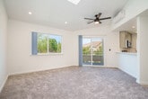 Located at 1447 Balhan Dr in Concord, California, this well-appointed 2-bedroom, 3-bathroom single-story home offers a clean, modern aesthetic throughout. The open-concept living and kitchen area forms the heart of the home, with the kitchen featuring gray shaker-style cabinetry, white quartz countertops, a stainless steel appliance suite including a gas range, microwave, dishwasher, and refrigerator, plus light wood-look flooring. A partial wall separates the kitchen from the carpeted living room, which benefits from a ceiling fan, a wall-mounted mini-split unit, and sliding glass door access to an outdoor space. The primary bedroom offers vaulted ceilings, a ceiling fan, plush carpet, and a sliding glass door leading outside, while its en-suite bathroom includes a dual-sink vanity with gray cabinetry and a separate water closet. The second bedroom is equally comfortable, featuring carpet flooring, a wall-mounted mini-split for climate control, and a closet. Additional bathrooms include a full bath with a tub/shower combo and tile surround. Throughout the home, large windows invite ample natural light, and the bright, neutral palette creates a fresh, move-in-ready atmosphere.