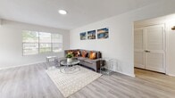 Located at 6300 Old Canton Rd in Jackson, Mississippi, this single-floor residence offers a well-organized layout with a thoughtful blend of modern updates and comfortable living spaces. The bright living room features light wood-look flooring, neutral walls, and a large window that invites natural light, creating an open and welcoming atmosphere. The galley-style kitchen has been tastefully updated with white cabinetry, brushed nickel hardware, marble-look countertops, stainless steel appliances including a refrigerator, range, and dishwasher, and durable wood-look flooring. The primary bedroom is generously sized, complete with plush carpeting, a ceiling fan with light, and large sliding glass doors fitted with vertical blinds that provide outdoor views and natural light. It also features a walk-in closet with dual shelving sections offering ample storage. Additional bedrooms are carpeted and equipped with ceiling fans, windows for natural light, and convenient access to desks and storage. Both bathrooms are finished with marble-look vanity countertops, white cabinetry, wood-look flooring, and tub-shower combinations, maintaining a clean and consistent aesthetic throughout the home.