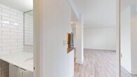 Located in the heart of Vancouver's West End at 1255 Pendrell St, this efficiently designed studio suite offers a bright and functional single-floor layout. The open-concept living area is finished with light-toned laminate hardwood flooring that runs throughout, contributing to a clean, modern aesthetic. Crisp white walls and a neutral palette keep the space feeling fresh and airy.

A standout feature of the living area is the expansive floor-to-ceiling window spanning the full width of one wall, flooding the interior with natural light and framing impressive views of the surrounding Vancouver skyline and lush greenery. A baseboard heating system runs along the window wall, ensuring year-round comfort.

The kitchen is neatly tucked into an alcove and features white cabinetry, a dark tile backsplash, a stainless steel dishwasher, and a full-size stainless steel refrigerator, providing all the essentials within a compact and well-organized footprint.

The bathroom is tastefully finished with classic white subway tile extending from floor to ceiling, a tiled floor, a white vanity with a stone-topped countertop, and a glass-enclosed shower, creating a clean and timeless look. Overall, this suite offers a well-appointed and practical living space in one of Vancouver's most vibrant and walkable neighborhoods.