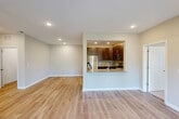 Located at 1641 Omaha Ct in Hamilton, NJ, this well-appointed 2-bedroom, 2-bathroom single-floor home offers a thoughtfully designed layout with modern finishes throughout. Light-toned luxury vinyl plank flooring flows through the main living areas, complemented by recessed lighting and a clean, neutral color palette that creates a bright and welcoming atmosphere.

The open-concept living room connects seamlessly to the kitchen via a pass-through opening, making the space feel expansive and ideal for entertaining. The kitchen is equipped with rich dark-wood cabinetry, granite countertops, a subway tile backsplash, and a full suite of stainless steel appliances, including a refrigerator, gas range, microwave, and dishwasher.

The spacious primary bedroom offers generous proportions, with plush carpeting and ample natural light from a large window. A dedicated closet with built-in shelving provides practical storage. The second bedroom is similarly finished with carpet and a bright window overlooking greenery.

Both bathrooms feature granite vanity tops and clean white tilework, with one including a tub-shower combination with subway tile surround. A dedicated in-unit laundry room houses a full-size Whirlpool front-loading washer and dryer. The home also includes a closet for additional storage needs.