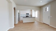 Located at 5811 102nd Street in Lubbock, Texas, this single-story home offers a clean, modern interior designed for comfortable living. The open layout is highlighted by light hardwood-style flooring that runs throughout, contributing to a bright and cohesive aesthetic. Neutral wall tones and crisp white trim create a fresh, move-in-ready atmosphere that complements a variety of décor styles.

The main living area is generously proportioned, featuring recessed lighting that provides even, ambient illumination across the space. A distinctive arched entryway adds an elegant architectural detail, lending character and visual interest as it connects the living area to the hallway beyond. The hallway leads further into the home, offering a glimpse of additional rooms bathed in natural light.

Ceiling-mounted HVAC vents are thoughtfully integrated throughout, ensuring year-round comfort. The consistent use of quality finishes — from the smooth walls to the well-maintained flooring — reflects careful attention to detail. The overall ambiance of the home is calm, airy, and welcoming, making it an ideal setting for both everyday living and entertaining. This Lubbock property combines functional design with understated style in a well-organized single-floor plan.
