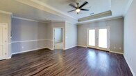 This 750 square foot apartment in Glenmoore, PA, offers a thoughtfully designed living space. The open-concept layout seamlessly integrates the living room and kitchen, creating a spacious feel. Rich hardwood flooring extends throughout the main living areas, adding warmth and elegance.

The kitchen boasts modern stainless steel appliances, white cabinetry, and ample counter space, ideal for culinary enthusiasts. A ceiling fan in the living area ensures comfort and air circulation.

The bedroom, measuring 170 square feet, features plush carpeting and a walk-in closet, providing ample storage. The bathroom is well-appointed with a single vanity and large mirror.

Crown molding and wainscoting add architectural interest to the space. French doors in the living area lead to an outdoor space, allowing natural light to flood the interior. The apartment's neutral color palette provides a versatile backdrop for various decor styles.

This efficient one-floor layout maximizes functionality, making it an ideal home for singles or couples seeking a modern, low-maintenance living space in a desirable location.
