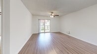 Located at 22356 Calibre Ct in Boca Raton, FL, this well-appointed two-bedroom, two-bathroom residence offers a comfortable and functional single-floor layout. The open-concept living and dining area is bright and airy, featuring wood-look flooring, a ceiling fan, textured ceilings, and sliding glass doors that lead to a private balcony overlooking lush, manicured grounds with palm trees and garden walkways. The kitchen is equipped with dark espresso cabinetry, granite-style countertops, black appliances including a range, microwave, refrigerator, and dishwasher, plus a double sink and easy access to a nearby closet. The primary bedroom offers hardwood-style flooring, a ceiling fan, and generous proportions, while the second bedroom features soft carpeting and a large window with vertical blinds that frames outdoor greenery. Both bathrooms are clean and functional, with one featuring a full tub/shower combo, granite-topped vanity, and wood-look flooring. Storage is plentiful with four closets, including a carpeted walk-in with wire shelving. A dedicated laundry area adds everyday convenience, completing this well-rounded Boca Raton residence.