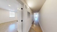 Located at 231 E 25th St in Little Rock, Arkansas, this thoughtfully designed one-bedroom, one-bathroom residence offers a contemporary living experience across a single, well-organized floor. Polished concrete floors flow throughout the entire unit, lending a clean, industrial-modern aesthetic that ties each space cohesively together.

The open-concept main area seamlessly integrates the living room, dining room, and kitchen, creating a bright and airy environment. Large multi-pane windows allow abundant natural light to fill the space, while a ceiling fan overhead adds comfort. The kitchen is a standout feature, showcasing light wood cabinetry, striking green tile backsplash, stainless steel appliances including a range with hood vent and a side-by-side refrigerator, and a dramatic waterfall-edge quartz island with an undermount sink and matte black faucet.

The spacious primary bedroom offers a ceiling fan, recessed lighting, and access to a generous walk-in closet outfitted with wire shelving. The bathroom is elegantly appointed with a light wood vanity, gray stone countertop, matte black fixtures, a large framed mirror, and a tiled tub-shower combination. Additional functional spaces include a dedicated laundry area, pantry, utility room, and a long hallway with terrazzo-style flooring connecting the rooms.