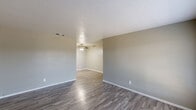 Located at 575 W Dickey Rd in Grand Prairie, Texas, this single-story, 4-bedroom, 2-bathroom home offers a well-organized and functional layout. The open-concept living and dining area flows seamlessly together, finished with durable wood-look laminate flooring and neutral taupe-toned walls that create a clean, cohesive atmosphere throughout. Ceiling fans are present in the living areas and bedrooms, providing both comfort and style. A large front-facing window in the living room allows natural light to fill the space.

The kitchen is a standout feature, showcasing white shaker-style cabinetry, granite-look countertops, a mosaic tile backsplash, and stainless steel appliances including a range, microwave, and refrigerator. The galley-style layout maximizes efficiency and storage.

Each of the four bedrooms is equipped with a ceiling fan and wood-look flooring. The primary bedroom offers a comfortable footprint, while all bedrooms benefit from abundant closet space — a notable highlight with eight closets distributed across the home.

The two bathrooms are finished in a clean, modern style, each featuring a tub-shower combination with brushed nickel fixtures, white vanity cabinetry with white countertops, and wood-look flooring. The overall design of this home emphasizes practicality and modern updates throughout.