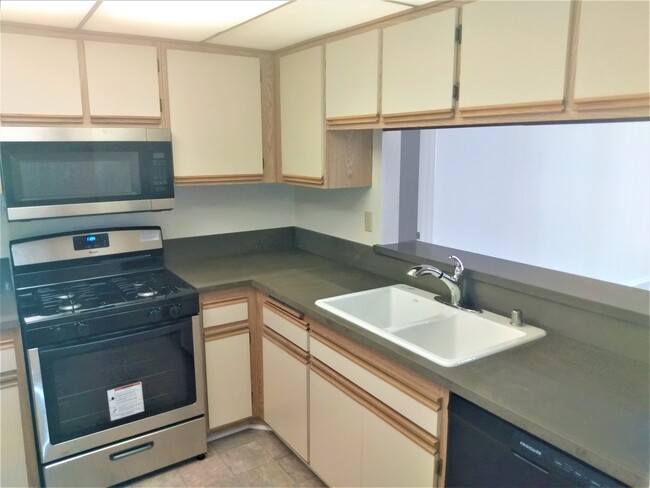 Kitchen w/ all new appliances - Palms Crest Apartments