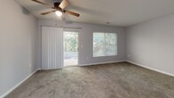 Located at 101 Arbor Run Dr in Lincolnton, NC, this single-floor, 2-bedroom, 2-bathroom home offers a practical and comfortable layout. The living room is a bright, open space featuring plush carpeting, a ceiling fan with light fixture, a sliding glass door leading to a patio, and an additional window—both offering views of surrounding greenery. The textured ceilings are consistent throughout the home, adding a classic residential character. The kitchen is well-equipped with warm oak cabinetry, ample counter space, and white appliances including a range, dishwasher, and refrigerator, all set over easy-to-maintain hard flooring. Both bedrooms are carpeted and finished in neutral gray tones, each with windows that bring in natural light and views of the tree-lined exterior. The primary bedroom is generously sized and offers ample room for furnishings. Both bathrooms include a full tub-shower combination, with one featuring wood-toned cabinetry and hard flooring. A dedicated laundry room with overhead wire shelving and hard flooring adds everyday convenience. The home's straightforward single-floor design ensures easy accessibility and efficient use of space throughout.