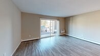 Located at 60 Sandy Ln in Warwick, Rhode Island, this single-floor, two-bedroom, one-bathroom unit offers a practical and comfortable layout across a well-proportioned floor plan. Consistent wood-look flooring flows throughout the living spaces, lending a cohesive and modern feel.

The open-concept kitchen and living room serves as the heart of the unit. The kitchen features warm wood cabinetry, granite-style countertops, a gas range, and a full-size refrigerator, with a pass-through counter connecting it seamlessly to the living area. The living room is bright and airy, anchored by a large sliding glass door that opens to a private patio and lets in generous natural light.

The spacious primary bedroom is generously sized, offering ample room for furniture arrangement, and is complemented by a large window with outdoor views. The second bedroom is well-proportioned with its own window and easy access to the hallway. Both rooms benefit from baseboard heating. The unit includes four closets total, providing abundant storage throughout.

The full bathroom is clean and functional, featuring a tub/shower combination, a white vanity with countertop, and wood-look flooring. A hallway connects all rooms efficiently, completing this well-organized single-level layout.