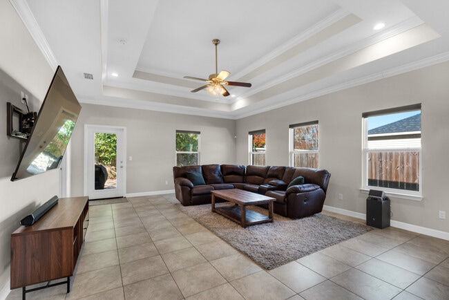 Living room has a huge TV, surround sound, blackout shades, and huge couch - 28 Snook Rd