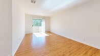 Located at 93 Richards Ave in Norwalk, CT, this well-appointed 2-bedroom, 3-bathroom residence offers a thoughtfully designed single-floor layout. The combined living and dining area serves as the heart of the home, featuring warm hardwood flooring, bright white walls, and a sliding glass door that floods the space with natural light and opens to a private balcony with pleasant tree-lined views.

The galley-style kitchen is efficiently arranged with rich dark wood cabinetry, white countertops, a stainless steel sink, and a full suite of stainless steel appliances including a refrigerator, oven, and dishwasher, all set atop matching hardwood floors.

Both bedrooms are carpeted and offer a comfortable, peaceful retreat. The primary bedroom is notably spacious and features a sliding glass door leading directly to the balcony, providing an abundance of natural light and outdoor access. The second bedroom includes a window with views of surrounding greenery. A carpeted hallway connects the bedrooms, flanked by multiple louvered-door closets providing generous storage.

All three bathrooms are finished with hardwood floors, rich wood vanities with white countertops, and clean white walls. The bathrooms include both shower and vanity configurations. Additional conveniences include a dedicated laundry area and utility room, rounding out this functional and comfortable home.
