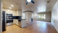 This single-story, one-bedroom, one-bathroom home on Grouse Run Drive in Stockton, California offers a well-organized layout with a comfortable, functional design throughout. The open-concept living, dining, and kitchen area serves as the heart of the home, featuring wood-look flooring, crown molding, a ceiling fan, and a fireplace that anchors the living space. Large windows invite generous natural light and offer views of the surrounding greenery. The kitchen is well-appointed with white shaker-style cabinetry, dark countertops, a contrasting tile backsplash, a peninsula with additional workspace, and a full suite of stainless steel appliances including a refrigerator, range, microwave, and dishwasher. The bedroom is a comfortable retreat with plush carpeting, a large window, crown molding, and a mirrored sliding-door closet that enhances the sense of space. A convenient in-unit laundry closet is accessible directly from the bedroom. The bathroom features wood-look flooring, dark countertops, ample vanity storage, and a full shower-tub combination. Two closets provide additional storage throughout the home, rounding out this practical and move-in-ready residence.