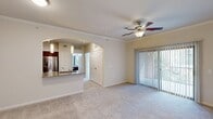 This 610 square foot apartment offers a thoughtful blend of comfort and functionality. The single-floor layout comprises one bedroom, one bathroom, and an open-concept living and kitchen area. The bedroom, measuring 130 square feet, provides a cozy retreat with a ceiling fan and large window for natural light. A spacious closet with built-in shelving offers ample storage.

The modern kitchen boasts dark wood cabinetry, granite countertops, and stainless steel appliances, including a refrigerator, stove, and built-in microwave. Adjacent to the kitchen, the living area features plush carpeting and a sliding glass door leading to an outdoor space, perfect for relaxation or entertainment.

The bathroom is equipped with a shower/tub combination, a wooden vanity with granite countertop, and wood-look flooring. Throughout the apartment, neutral wall colors and crown molding create a clean, contemporary aesthetic. Ceiling fans in main living spaces and the bedroom provide air circulation and comfort. The apartment's design maximizes space efficiency while maintaining an open, airy feel, making it an ideal home for singles or couples seeking a modern, low-maintenance living space.