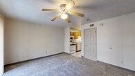 Located at 132 Andrew Pl in West Lafayette, Indiana, this efficiently designed single-floor unit offers a practical and comfortable layout across five distinct spaces. The carpeted living room serves as the central gathering area, featuring a ceiling fan with light fixture, a textured ceiling, and a sliding glass door dressed with vertical blinds that allows natural light to filter in and provides outdoor access. The open sightline from the living room into the kitchen creates a connected, airy feel despite the compact footprint. The kitchen is equipped with warm oak cabinetry, a white electric range, an over-the-range microwave, a dishwasher, a refrigerator, and light tile flooring — offering all essential appliances in a neatly organized space. The full bathroom includes a tub-shower combination, a toilet, and a wood-toned vanity with sink, finished with clean white tile flooring and neutral walls. A dedicated closet provides convenient storage, while the utility room adds valuable functional space. Throughout the unit, neutral wall tones and consistent finishes create a cohesive, understated aesthetic well-suited for practical everyday living in the West Lafayette area.