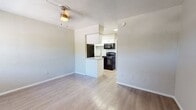 This 380 square foot apartment, located in Waterside Village, Saint Petersburg, FL, offers a well-designed living space in a compact footprint. The single-floor layout comprises one bedroom, one bathroom, and a kitchen, efficiently arranged to maximize functionality.

The primary bedroom, measuring 130 square feet, provides ample space for a comfortable sleeping area. It features light-colored walls, warm wood-tone flooring, and a built-in closet with white paneled doors, offering both storage and style. The room is equipped with a modern air conditioning unit for year-round comfort.

The kitchen showcases a contemporary design with white cabinetry, subway tile backsplash, and granite countertops. Black appliances, including a refrigerator, stove, and over-the-range microwave, add a sleek contrast. A small peninsula extends from the main kitchen area, providing additional counter space and defining the transition to the living area.

The bathroom continues the modern aesthetic with a white tile surround for the bathtub/shower combination, a granite-topped vanity, and wood-look tile flooring. The space is compact yet functional, with clean lines and neutral colors.

Throughout the apartment, the light-colored walls and wood-tone flooring create a bright, open feel, making the space appear larger. The layout is designed for easy flow between areas, ideal for single occupancy or a couple seeking an efficient living space in a desirable Saint Petersburg location.