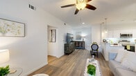 This well-appointed single-floor residence offers a bright, contemporary living experience with a cohesive design carried throughout. The open-concept layout connects the living and dining areas seamlessly, both finished with warm wood-look flooring that extends across the entire space. The living area features vaulted ceilings, a ceiling fan with light fixture, and large windows that invite generous natural light, creating an airy and comfortable atmosphere.

The kitchen is a standout feature, outfitted with crisp white shaker cabinetry, granite-look countertops, a subway tile backsplash, and a full suite of stainless steel appliances including a range, microwave, dishwasher, and refrigerator. Dual pendant lights hang above the open peninsula, enhancing both function and style.

The bedrooms are calm and spacious, each with wood-look flooring, bright white walls, and windows dressed with blinds and curtains for privacy and light control. The bathroom features a clean white vanity with a granite countertop and undermount sink, positioned conveniently adjacent to the bedroom.

Throughout, the residence maintains a clean, modern aesthetic defined by white walls, consistent flooring, and contemporary fixtures — offering a comfortable and functional living environment.