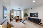 Located in Peoria, AZ, this thoughtfully designed one-bedroom, one-bathroom residence offers a comfortable and modern living experience across a single floor. The open-concept kitchen and living area serves as the heart of the home, where light wood-look flooring, neutral tones, and abundant natural light from large windows create a warm and inviting atmosphere. Ceiling fans in both the living room and bedroom add to the comfort of the space.

The kitchen is equipped with stainless steel appliances, white cabinetry, a subway tile backsplash, and a granite-topped island with bar seating — ideal for both cooking and casual dining. A pendant light above the island adds a stylish accent.

The living area is generously sized, offering room for a full sectional sofa, coffee table, and a dedicated workspace nook bathed in natural light from a large window with sheer curtains.

The bedroom provides a comfortable retreat with its own ceiling fan, light-toned walls, and hardwood-style flooring. The bathroom features a granite vanity, subway-tiled tub and shower combination, and clean, neutral finishes. A dedicated in-unit laundry room with side-by-side washer and dryer adds everyday convenience. A hallway and closet complete the efficient, well-organized layout.