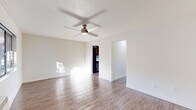 Located at 1801 W Garvey Ave in Alhambra, CA, this one-bedroom, one-bathroom unit offers a well-organized and efficiently designed single-floor layout. Wood-look flooring runs throughout the entire space, lending a cohesive and clean aesthetic to every room. Ceiling fans are present in multiple rooms, contributing to comfortable year-round living.

The bright living room is a welcoming focal point, featuring a fireplace with a wood mantel and ample natural light. It flows naturally into the dining area, creating an open and functional common space. The kitchen is well-appointed with rich dark cabinetry, white countertops, a mosaic tile backsplash, stainless steel gas range, and recessed lighting. A pantry provides additional storage, and a sliding glass door leads directly from the kitchen area to a private patio with outdoor views.

The bedroom offers a comfortable retreat, complete with a ceiling fan, wall-unit HVAC, a window for natural light, and a mirrored sliding-door closet. The bathroom is clean and functional, featuring a full bathtub and shower combination with a curved curtain rod, a white vanity, and overhead cabinetry for storage. A hallway connects the rooms with ease, completing this practical and well-designed unit.