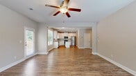 Located at 429 Ireland Ln in Dallas, GA, this two-story home offers 4 bedrooms and 5 bathrooms thoughtfully distributed across two well-proportioned floors. The main level welcomes you with an open-concept layout connecting the living room and kitchen, all finished with warm hardwood-style flooring. The kitchen is a standout feature, showcasing white shaker cabinetry, granite countertops, a central island, tile backsplash, stainless steel appliances, and recessed lighting. A pantry and dedicated dining area add further function to the main level, along with an attached garage with direct interior access and a dedicated laundry room complete with washer and dryer hookups. The upper floor hosts the bedrooms, including a generously sized primary suite. Bedrooms feature plush carpet flooring, natural light from large windows, and access to closets—including walk-in closets with wire shelving systems. Bathrooms are clean and functional, featuring tub-shower combinations and hardwood-style flooring. With eight closets spread throughout, storage is abundant. The neutral color palette and consistent finishes create a cohesive, move-in-ready ambiance throughout the entire home.
