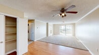 This single-floor, 2-bedroom, 1-bathroom unit in Slidell, Louisiana, offers a practical and comfortable layout with neutral tones and a mix of hardwood-style and carpeted flooring throughout. The living room serves as the central gathering space, featuring crown molding, a ceiling fan with light fixture, a textured ceiling, and a sliding glass door that opens to an outdoor view, allowing abundant natural light to fill the room.

The kitchen is well-appointed with warm oak cabinetry, granite-style countertops, and white appliances including a refrigerator, dishwasher, range, and built-in microwave. A window with vertical blinds provides additional natural light, and hardwood-style flooring ties the space together seamlessly.

Both bedrooms are carpeted and feature neutral walls, textured ceilings, and windows with vertical blinds that frame outdoor views. The primary bedroom is generously sized with a closet, while the second bedroom offers comparable comfort. The bathroom includes an extended vanity with warm wood cabinetry, granite-style countertops, a large mirror, and hardwood-style flooring, providing a clean and functional space. A hallway connects the rooms, completing the efficient floor plan.
