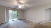 This well-appointed one-bedroom, one-bathroom residence in Mobile, Alabama offers a thoughtfully designed single-floor layout. The kitchen is a functional highlight, featuring white cabinetry, stone-look countertops, stainless steel appliances including a dishwasher and range, light wood-look flooring, and a pendant light that adds a modern touch. The living area flows naturally from the kitchen, providing comfortable everyday living space.

The spacious primary bedroom is carpeted and filled with natural light, with a ceiling fan overhead and a sliding glass door that opens to a private balcony overlooking lush greenery. A second carpeted room with a ceiling fan and a large window offers additional versatility. The walk-in closet provides ample storage with built-in wire shelving. The bathroom is clean and bright, featuring a tiled tub-shower combo, wood-look flooring, and a vanity with a stone-look countertop.

A dedicated in-unit laundry room adds everyday convenience. Throughout the space, neutral tones, textured ceilings, and consistent finishes create a cohesive, move-in-ready environment. Located in the 36695 zip code of Mobile, AL, this residence combines practical functionality with comfortable living.