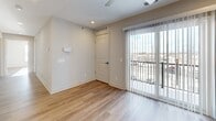 Located at 4781 Transit Rd in Depew, NY, this well-appointed 2-bedroom, 2-bathroom unit offers a thoughtfully designed single-floor layout with modern finishes throughout. The open-concept kitchen is a standout feature, showcasing a large quartz-topped island with an undermount sink, rich dark-espresso cabinetry, stainless steel appliances including a range, microwave, and refrigerator, and stylish pendant lighting. Light-toned hardwood-style flooring flows consistently throughout the entire unit, creating a cohesive and clean aesthetic. The living area benefits from large windows that invite abundant natural light. The spacious primary bedroom includes access to an en-suite bathroom equipped with a glass-enclosed walk-in shower, a dark-cabinetry vanity with a white countertop, and hardwood-style flooring. The second bathroom features a full soaking tub with a shower. The generously sized primary bedroom offers ample space, while the second bedroom is bright and airy, with corner windows providing open exterior views. A dedicated in-unit laundry room includes a full-size washer and overhead storage shelving. A private balcony accessible via sliding glass doors adds an outdoor retreat to this functional and modern home.