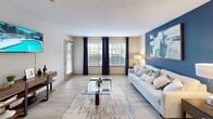 Located in Huntsville, Alabama, this single-floor residence offers two bedrooms and two bathrooms within a thoughtfully designed, open layout. Light wood-style flooring flows throughout the home, creating a cohesive and airy feel. The spacious living room features large windows with bold navy drapery, a distinctive blue accent wall, and abundant natural light, lending a welcoming and stylish ambiance. It connects seamlessly to the dining area and kitchen, which boasts granite countertops, gray cabinetry, a breakfast bar, and a handy pantry closet. The primary bedroom is a comfortable retreat with sliding glass doors opening to a private outdoor balcony, offering pleasant outdoor views. The second bedroom features its own blue accent wall and a closet with mirrored sliding doors. Both bathrooms are finished with granite-topped vanities and tiled tub-shower combinations. The home also includes two dedicated closets for additional storage. Textured ceilings are present throughout, adding a classic touch. The single-floor plan ensures easy accessibility and a smooth, functional flow between all living spaces, making this residence a practical and attractive option in Huntsville's Rime Village community.