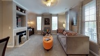 Located at 801 Elmcroft Blvd in Rockville, Maryland, this two-floor residence offers a cohesive blend of modern design and comfortable living across its thoughtfully appointed spaces. The kitchen is a standout feature, showcasing rich dark cabinetry with sleek hardware, light quartz countertops, a classic subway tile backsplash, and a full suite of stainless steel appliances including a gas range, built-in microwave, dishwasher, and refrigerator. Wood-look flooring anchors the kitchen and flows seamlessly into the adjacent areas. The living room is bright and welcoming, featuring multiple large windows that draw in generous natural light, plush carpeting, a ceiling fan, a fireplace with built-in shelving, and ample room for relaxed entertaining. Multiple bedrooms are present throughout the home, each finished with soft carpeting, neutral walls, and well-sized windows. One bedroom notably includes a private walk-in closet and direct access to an outdoor space via a glass-paned door. The bathrooms are finished with dark vanity cabinetry, white countertops, wood-look tile flooring, and full soaking tub and shower combinations, with windows providing natural ventilation. The overall palette of warm grays and rich browns creates a consistently polished and inviting atmosphere throughout.