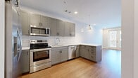 Located at 601 Press Pl in Nashville, TN, this well-designed one-bedroom unit offers a thoughtfully laid-out single-floor plan that maximizes every square foot. Warm hardwood-style flooring runs consistently throughout the space, lending a cohesive and inviting feel.

The kitchen and living area form an open, combined space at the heart of the unit. The kitchen is outfitted with gray shaker-style cabinetry, a white subway tile backsplash, stainless steel appliances — including a French door refrigerator, range, microwave, and dishwasher — and a white quartz peninsula countertop with pendant lighting overhead. Recessed lighting provides bright, even illumination throughout.

The bedroom offers a comfortable, private retreat with a ceiling fan, large windows fitted with blinds that invite natural light and urban views of the surrounding Nashville neighborhood. An additional windowed area and a sliding glass door further enhance the sense of openness.

A dedicated walk-in closet serves the bedroom with a custom organization system featuring shelving, hanging rods, and built-in drawers — providing ample, well-structured storage. The clean white walls and neutral color palette throughout the unit create a bright, modern ambiance well-suited to urban living in the heart of Nashville.