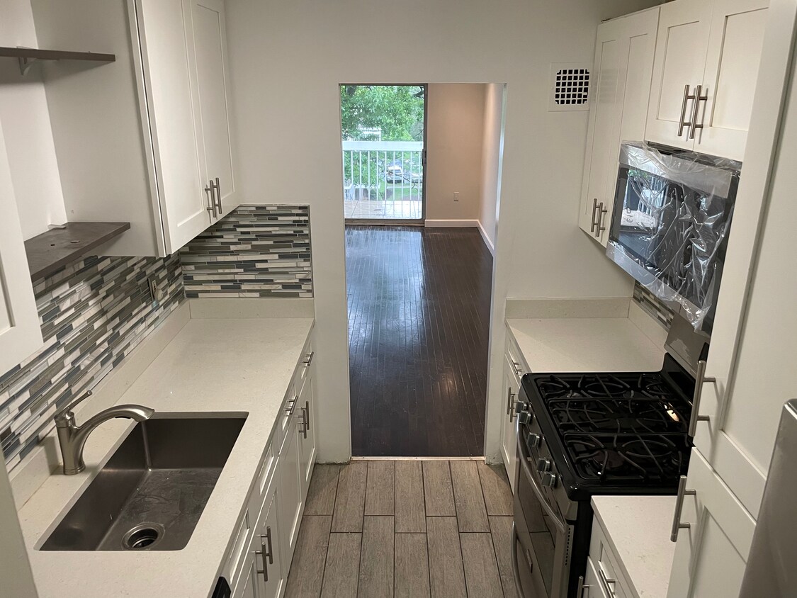 Kitchen with brand new dishwasher and refrigerator. - 3240 Hewitt Ave