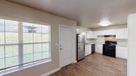 Located at 731 29th St NW in Roanoke, Virginia, this two-story residence offers a practical and functional layout across both levels. The main floor centers around a generously sized kitchen outfitted with white shaker-style cabinetry, light countertops, a stainless steel double-basin sink, and black appliances including a range, dishwasher, and refrigerator. Wood-look flooring runs throughout the main living areas, lending a clean and cohesive appearance. A dedicated laundry area on this level includes washer and dryer hookups alongside a water heater, topped with a storage shelf above. A half bathroom on the main floor features a vanity with an oval sink, large mirror, and wood-look flooring.

Upstairs, multiple bedrooms feature neutral-toned carpet, natural light from sizable windows with blinds, and flush-mount ceiling lighting. The full bathroom on this level is equipped with a tub-shower combination, curved curtain rod, grab bars, a window for natural ventilation, and wood-look flooring. Throughout the home, neutral wall tones and consistent trim work create a clean, move-in ready environment suited for comfortable everyday living.