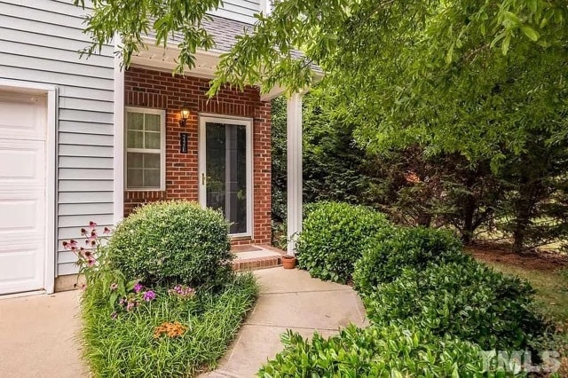 End unit front door with side yard and garage - 245 Plaza Dr