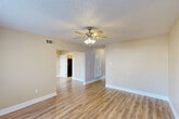 Located at 303 Russell Ave in Belle Chasse, Louisiana, this two-story home offers four bedrooms and four full bathrooms spread evenly across two floors. Light-toned, hardwood-style flooring runs throughout the home, creating a cohesive and clean aesthetic. Each bedroom is fitted with a ceiling fan and light kit, and several rooms benefit from natural light streaming through sizable windows with blinds. The primary bedroom includes a generous closet with bi-fold doors and an adjacent private space. The galley-style kitchen is well-appointed with warm wood cabinetry, granite-look countertops, black appliances including a gas range and refrigerator, and a sink with a window view. It connects seamlessly to a combined dining area. The living room is open and bright, with a ceiling fan and direct sightlines to the staircase and dining spaces. Two hallways serve as connectors between the bedrooms and bathrooms, with flush-mount lighting overhead. The four bathrooms feature wood-tone vanities, white countertops, and lighted mirrors. Additional conveniences include a pantry, laundry room, abundant closet storage across eight closets, and an outdoor patio — rounding out a well-organized, functional home.