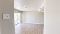 Located at 7047 Westwind Dr in El Paso, Texas, this two-bedroom, one-bathroom single-floor residence offers a practical and comfortable layout designed for everyday living. The open living area features light wood-tone flooring, neutral gray walls, and a textured ceiling that adds subtle character. A sliding glass door leads to a private balcony, allowing natural light to fill the space while providing outdoor access and views of the surrounding area.

The kitchen is efficiently designed with white cabinetry, light stone countertops, a stainless steel refrigerator, and an electric range — providing all essential appliances in a clean, functional arrangement. Wood-look flooring continues through the kitchen, maintaining a cohesive aesthetic throughout the main living areas.

Both bedrooms are carpeted for comfort, with neutral tones and windows that allow in natural light. The primary bedroom is a well-proportioned space that includes a dedicated closet, while a separate walk-in closet features dual shelving rods and carpeted flooring, offering generous storage. The bathroom is finished with a white vanity, light stone countertop, tub-shower combination, and a well-lit mirror, presenting a clean and functional design. The overall ambiance is bright, neutral, and move-in ready.