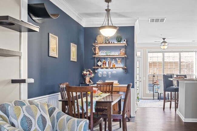 Building Photo - This inviting two-level townhome offers comfort and style, featuring gleaming hardwood floors on ...