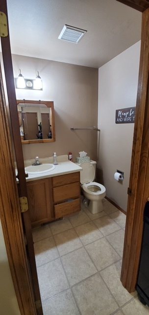 Downstairs half-bath (under remodel - new flooring, handles added to drawers, new mirror) - 1007 E Elm Dr