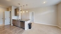 Located at 16310 Croft Dr in Huntersville, NC, this single-floor, 2-bedroom, 2-bathroom home offers a functional and thoughtfully designed living space. The open-concept kitchen features granite countertops, dark cabinetry, a subway tile backsplash, stainless steel dishwasher, and a peninsula with pendant lighting overhead — flowing seamlessly into the carpeted living area. Large windows with blinds throughout the home invite generous natural light, and a door off the living area provides access to an outdoor area. Both bedrooms are carpeted and equipped with ceiling fans; each offers comfortable proportions, with the primary bedroom providing a well-sized walk-in closet outfitted with wire shelving systems. The primary bathroom includes a dual-sink granite vanity with dark cabinetry and a glass-enclosed shower. The secondary bathroom mirrors the same design aesthetic with a granite-topped vanity, wood-look flooring, and a tub-shower combination. A dedicated laundry room accommodates a full-size side-by-side washer and dryer with overhead wire shelving for additional storage. The home's neutral color palette, consistent finishes, and practical layout make it a polished and move-in ready residence in the Huntersville community.