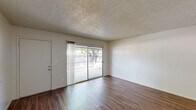 Located at 1213 Norwegian Ave in Modesto, California, this two-bedroom, one-bathroom single-story home offers a practical and comfortable layout. The interior is finished with warm wood-look laminate flooring throughout the main living areas, creating a cohesive and inviting atmosphere. The living room is bright and open, featuring clean white walls and a textured ceiling, providing a versatile space for everyday living. An entry area with the same durable laminate flooring leads seamlessly into the main living spaces. The kitchen is efficiently designed with white cabinetry, bold granite-style countertops, a gas range, and a window that brings in natural light and views of the surrounding greenery. Both bedrooms are finished with plush carpeting for added comfort. The spacious primary bedroom includes a ceiling fan with light, a wide window for natural light, and a sliding-door closet for convenient storage. The second bedroom is equally comfortable, also featuring carpet, a ceiling fan, and a window with outdoor views. The bathroom includes a full tub-shower combination with white tile surround and brushed nickel fixtures. Textured ceilings are consistent throughout the home, adding a classic residential character to every room.