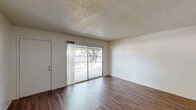 Located at 1213 Norwegian Ave in Modesto, California, this two-bedroom, one-bathroom single-story home offers a practical and comfortable layout. The interior is finished with warm wood-look laminate flooring throughout the main living areas, creating a cohesive and inviting atmosphere. The living room is bright and open, featuring clean white walls and a textured ceiling, providing a versatile space for everyday living. An entry area with the same durable laminate flooring leads seamlessly into the main living spaces. The kitchen is efficiently designed with white cabinetry, bold granite-style countertops, a gas range, and a window that brings in natural light and views of the surrounding greenery. Both bedrooms are finished with plush carpeting for added comfort. The spacious primary bedroom includes a ceiling fan with light, a wide window for natural light, and a sliding-door closet for convenient storage. The second bedroom is equally comfortable, also featuring carpet, a ceiling fan, and a window with outdoor views. The bathroom includes a full tub-shower combination with white tile surround and brushed nickel fixtures. Textured ceilings are consistent throughout the home, adding a classic residential character to every room.