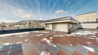 This property showcases an impressive rooftop terrace, providing a breathtaking 360-degree view of Montreal's urban landscape. The space is characterized by its large, open-air design, bordered by a sturdy metal railing for safety. The flooring consists of multicolored tiles, creating an interesting visual pattern across the terrace.

A notable feature is the small, white brick structure situated on one side of the terrace. This building has large windows and a door, suggesting it could serve as a rooftop lounge or utility room. The structure's clean, modern design complements the overall aesthetic of the space.

The terrace offers unobstructed views of Montreal's skyline, including prominent landmarks such as Mount Royal and various architectural highlights of the city. On clear days, the vista extends to the horizon, providing an exceptional urban panorama.

The rooftop's expansive nature makes it suitable for various uses, from casual relaxation to potential event hosting. Its elevated position not only offers stunning views but also a sense of privacy and exclusivity. This unique outdoor space adds significant value to the property, offering a rare urban retreat above the bustling city streets.