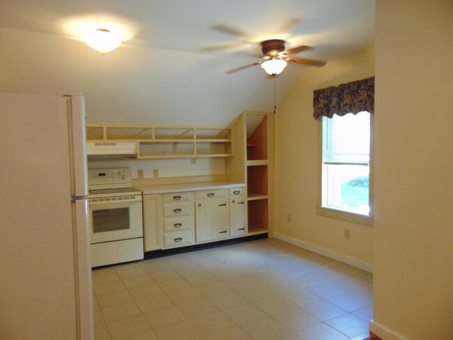 Kitchen from living room showing front window. - 61 West St