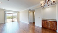 Located in the Studio City neighborhood of Los Angeles, this 1-bedroom, 2-bathroom residence on Riverside Drive offers a well-designed single-floor layout with a thoughtful mix of finishes and comfortable living spaces. The open-concept living and kitchen area serves as the heart of the home, where rich hardwood flooring extends throughout and crown molding adds a refined architectural touch. The kitchen is outfitted with warm wood cabinetry, granite countertops, a stone tile backsplash, stainless steel appliances, a skylight, and a convenient breakfast bar that connects seamlessly to the living area. Large sliding glass doors in the living room open to a private balcony offering sweeping views of lush tree canopies, the surrounding neighborhood, and the scenic hillside mountains beyond — an ideal setting for enjoying Southern California's sunny climate. The spacious primary bedroom features plush carpeting, crown molding, and a window framing tranquil outdoor views, creating a calm retreat. Two full bathrooms serve the residence — one with a tiled walk-in shower and rich wood vanity with granite countertop, and the other featuring a soaking tub with a glass-enclosed shower combo finished in neutral tile. Two hallways provide efficient flow throughout, completing this well-appointed Los Angeles residence.