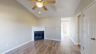 Located at 1481 Cantwell Ln in Swansea, Illinois, this single-floor home offers a well-designed layout with a variety of functional and comfortable living spaces. The living room serves as the heart of the home, boasting vaulted ceilings, a ceiling fan, and a sleek corner fireplace framed by a clean white surround — all set atop durable wood-look flooring that extends throughout the main areas. A hallway connects the living space to the rest of the home, creating an easy and natural flow. The kitchen is well-appointed with white cabinetry, granite-look countertops, and a full suite of stainless steel appliances including a refrigerator, range, over-the-range microwave, and dishwasher. A sliding glass door in the kitchen provides direct access to an outdoor deck, filling the space with natural light. The bedrooms feature plush carpet flooring and ceiling fans, offering a comfortable and quiet retreat. A full bathroom includes a vanity with ample counter space and a separate shower area. The dedicated laundry room is equipped with a full-size washer and dryer and includes a storage shelf, adding everyday convenience. Neutral tones and clean finishes throughout give the home a bright, move-in-ready feel.
