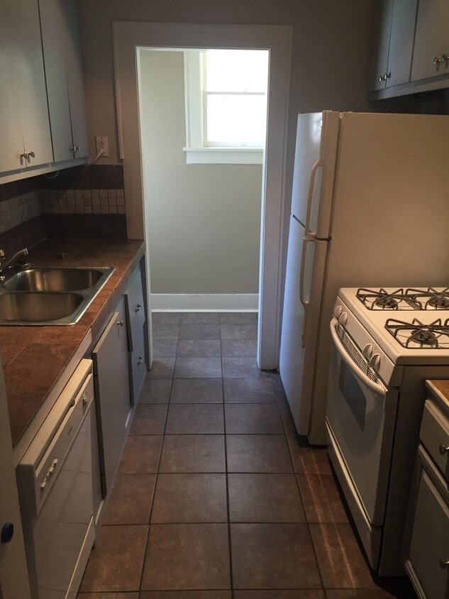 Kitchen with dishwasher, fridge, range, and disposal - 1926 Harold St