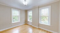 Located at 20 Eden St in Worcester, MA, this single-floor, 3-bedroom, 1-bathroom residence offers a well-organized layout with consistent finishes throughout. Gleaming light hardwood floors flow through the main living areas and all three bedrooms, lending warmth and cohesion to the space.

The spacious living area is bright and open, featuring crown molding, neutral beige walls, and multiple windows that invite generous natural light and views of surrounding greenery. A dedicated dining area is accented by warm yellow walls and an elegant chandelier, with tile flooring that transitions neatly into the galley-style kitchen. The kitchen is equipped with light wood cabinetry, granite-style countertops, a gas range, white appliances, a tile backsplash, and a window overlooking the exterior.

The three bedrooms are well-proportioned, each featuring hardwood floors and natural light from windows. Two bedrooms are finished in a calming blue-gray tone, while the primary bedroom includes a closet with a built-in rod and access to an additional room. The full bathroom features dark slate tile flooring, a tub-shower combo with sliding glass doors, a granite-top vanity, and white cabinetry for storage. A hallway connects the rooms, completing this practical and comfortable single-floor layout.