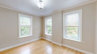 Located at 20 Eden St in Worcester, MA, this single-floor, 3-bedroom, 1-bathroom residence offers a well-organized layout with consistent finishes throughout. Gleaming light hardwood floors flow through the main living areas and all three bedrooms, lending warmth and cohesion to the space.

The spacious living area is bright and open, featuring crown molding, neutral beige walls, and multiple windows that invite generous natural light and views of surrounding greenery. A dedicated dining area is accented by warm yellow walls and an elegant chandelier, with tile flooring that transitions neatly into the galley-style kitchen. The kitchen is equipped with light wood cabinetry, granite-style countertops, a gas range, white appliances, a tile backsplash, and a window overlooking the exterior.

The three bedrooms are well-proportioned, each featuring hardwood floors and natural light from windows. Two bedrooms are finished in a calming blue-gray tone, while the primary bedroom includes a closet with a built-in rod and access to an additional room. The full bathroom features dark slate tile flooring, a tub-shower combo with sliding glass doors, a granite-top vanity, and white cabinetry for storage. A hallway connects the rooms, completing this practical and comfortable single-floor layout.