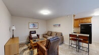 This 680 square foot single-story home in Fresno, CA, offers a compact yet comfortable living space. The property features two bedrooms and one bathroom, efficiently arranged to maximize the available area. The kitchen is a highlight, boasting modern amenities with honey-colored wooden cabinetry, granite countertops, and stainless steel appliances. The galley-style layout includes a gas range and ample storage space.

The living room, while modest in size, is thoughtfully designed with large windows that allow natural light to flood the space. Comfortable seating and a coffee table create a cozy atmosphere for relaxation or entertaining. The bedrooms are functional, with one offering space for two single beds, ideal for children or guests. The bathroom features updated fixtures, including a tiled shower and granite vanity top, matching the kitchen's aesthetic.

Throughout the home, neutral wall colors and carpeting in the bedrooms create a sense of continuity and space. Tiled flooring in the kitchen, living area, and bathroom adds a touch of elegance while being practical for easy maintenance. Circular ceiling lights in each room provide even illumination, enhancing the home's modern feel. Despite its compact size, this property offers a well-organized and inviting living environment.
