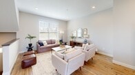 Located in Maple Grove, Minnesota, this well-designed two-story home offers three bedrooms, three bathrooms, and a functional layout spread across two evenly balanced floors. The main level features an open-concept living, dining, and kitchen area filled with natural light from large windows. The kitchen is a standout, boasting white shaker cabinets, a classic subway tile backsplash, quartz countertops, stainless steel appliances, and a central island with seating — ideal for both cooking and entertaining. Warm hardwood flooring flows throughout the main level, complementing the bright, neutral palette. The dining area sits adjacent to sliding glass doors that invite additional light and outdoor access. The living room is spacious and welcoming, featuring recessed lighting and a clean, contemporary aesthetic. Carpeted stairs with a wood-railed banister lead to the upper level, where all three bedrooms are located. The generously sized primary bedroom offers a large window and ample closet space. Two additional bedrooms provide comfortable accommodations, each with closets. The three bathrooms are finished with clean, modern fixtures — one featuring a glass-enclosed walk-in shower and another with a tub-shower combo. Hallways connect the rooms seamlessly, completing this thoughtfully arranged home.