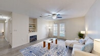 Located at 14801 Lemoyne Blvd in Biloxi, Mississippi, this well-appointed 2-bedroom, 2-bathroom single-story residence offers a practical and comfortable layout across a generously sized floor plan. The living room serves as the heart of the home, featuring a classic fireplace framed by built-in display shelves, a ceiling fan with light fixture, and French doors that invite natural light and provide outdoor access. Wood-style flooring flows throughout the space, lending a cohesive, modern feel. The galley-style kitchen is efficiently designed with ample cabinetry in a warm wood finish, laminate countertops, a full suite of appliances including a refrigerator, electric range, microwave, and dishwasher, and a pass-through to the rest of the home. A dedicated dining area with pendant lighting offers a comfortable space for meals. The spacious primary bedroom features a ceiling fan and easy closet access, while both bathrooms are equipped with vanities, generous counter space, and wood-style flooring. A dedicated laundry room with washer hookups adds everyday convenience. With six closets and a utility room, storage is abundant throughout this well-organized Biloxi residence.