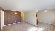 Located at 335 Florence Ave in Westville, NJ, this two-bedroom, one-bathroom single-floor residence offers a practical and comfortable layout. The living room serves as the heart of the home, highlighted by a striking full-length exposed brick accent wall that adds warmth and character to the space. Carpet flooring runs throughout the living area, and a sliding glass door floods the room with natural light while providing direct access to the outdoors. The living room flows into a combined dining and kitchen area, which features hardwood-style flooring and includes standard appliances, making for an efficient use of space. A hallway connects the main living areas to the private quarters, with ample storage provided by five closets distributed throughout the unit. Both bedrooms are carpeted and finished with neutral tones, offering a calm and restful atmosphere. The generously sized primary bedroom features two sliding-door closets, while the second bedroom includes its own closet as well. Each bedroom is equipped with a baseboard heating unit and a window that brings in natural light. The bathroom is well-appointed with tile flooring, a sliding-door tub and shower combo, and a vanity with storage.